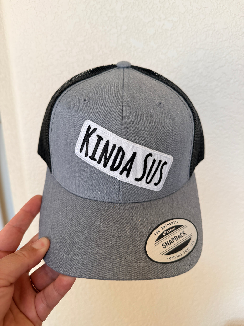 Grey and black structured trucker hat with Kinda Sus text patch – funny custom hat – Hedrick Hat Co
