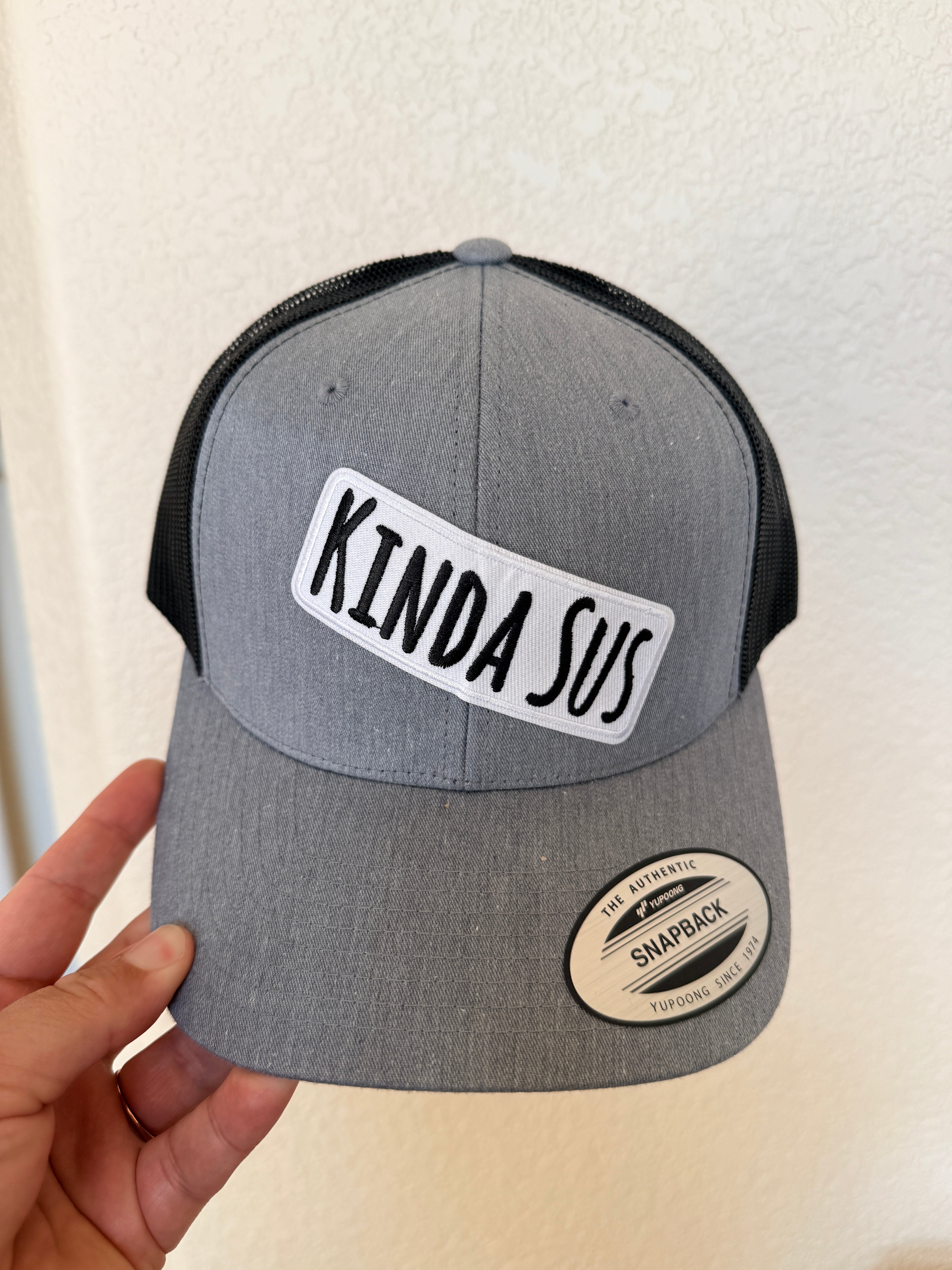 Grey and black structured trucker hat with Kinda Sus text patch – funny custom hat – Hedrick Hat Co